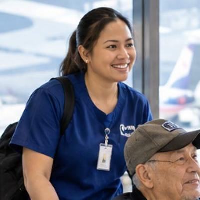 A caregiver accompanying a client through an airport